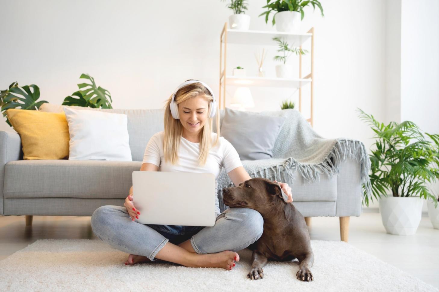 Professional reviewing budget documents with calculator and laptop in modern office setting