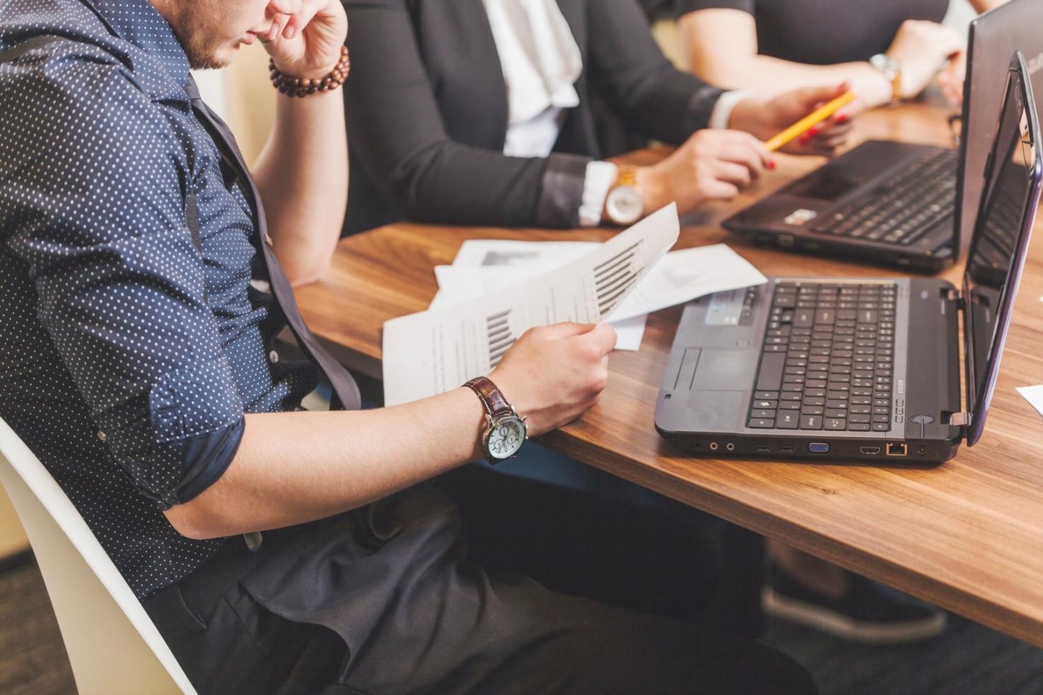 Department manager reviewing quarterly budget performance metrics on computer screen